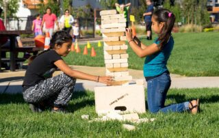 Kids building jenga puzzle at park