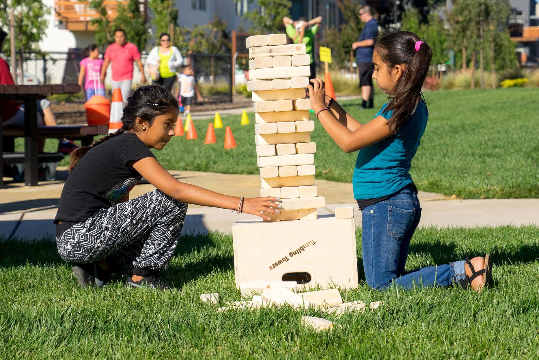 Kids building jenga puzzle at park