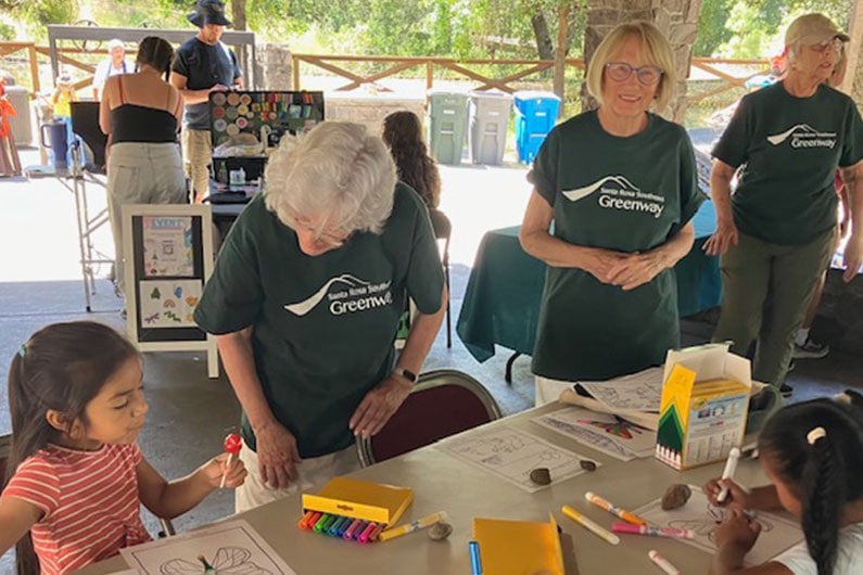 Southeast Greenway volunteers with kids coloring at table