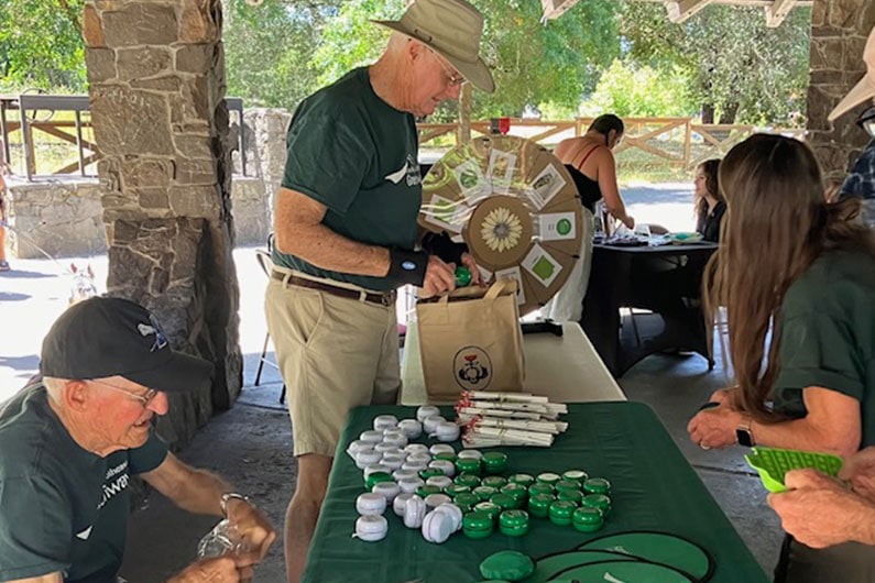 Southeast Greenway volunteers with wheel or fortune game