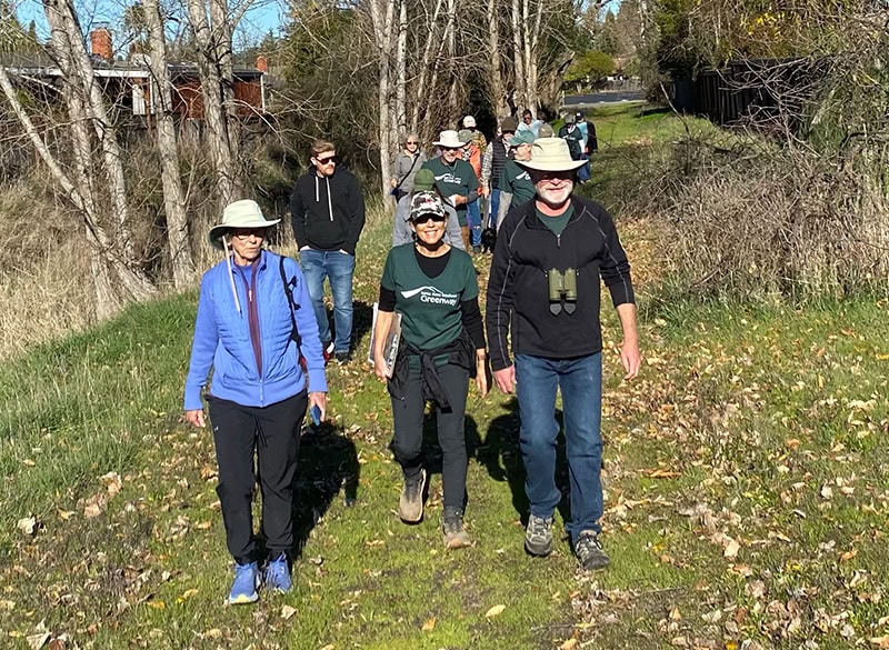 Group walking on a path along Southeast Greenway property in Santa Rosa