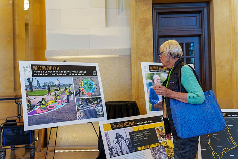 Thea Hensel, Chair of Southeast Greenway looking at display at event