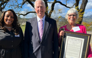 Congressman Mike Thompson standing next to Thea Hensel who is holding an award