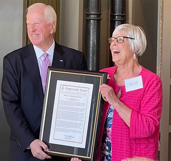 Photo of Congressman Mike Thompson on the left handing award to Thea Hensel on the right