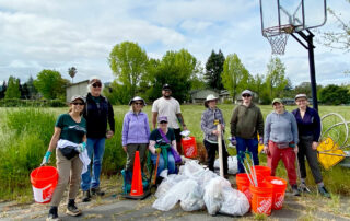 Volunteers gathered after clean-up day on the Southeast Greenway property