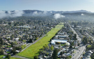 Drone photo of the Southeast Greenway with morning fog burning off in the distant hills