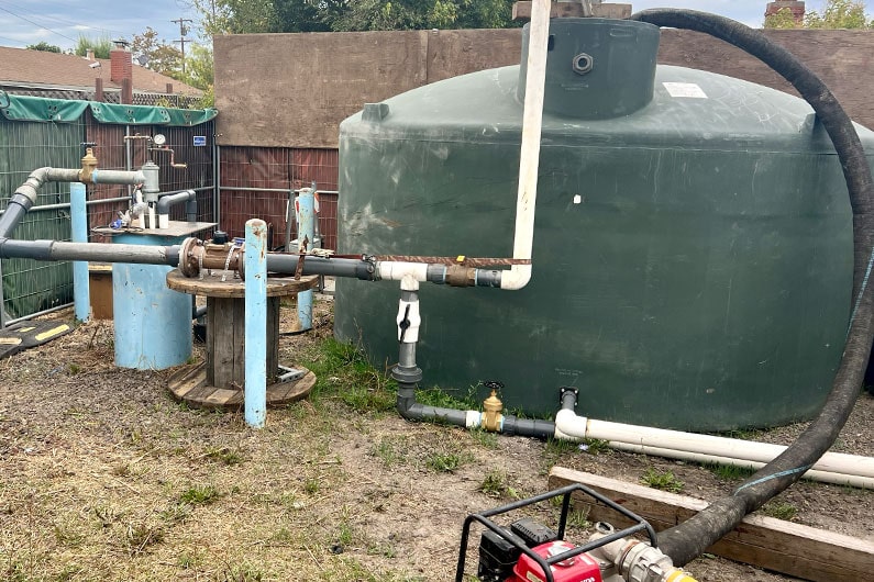 Well testing on the greenway with photo of large green storage tank and other equipment